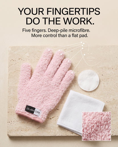 A pink textured fingertip cleansing glove is displayed on a beige stone slab with a white cotton pad and folded white cloth. Large text at the top reads, 'YOUR FINGERTIPS DO THE WORK.